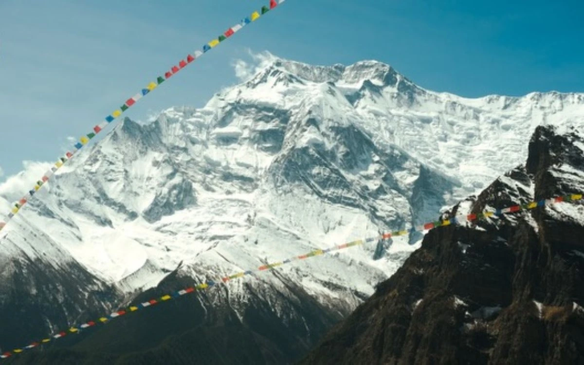 Snow-covered Annapurna peak with prayer flags