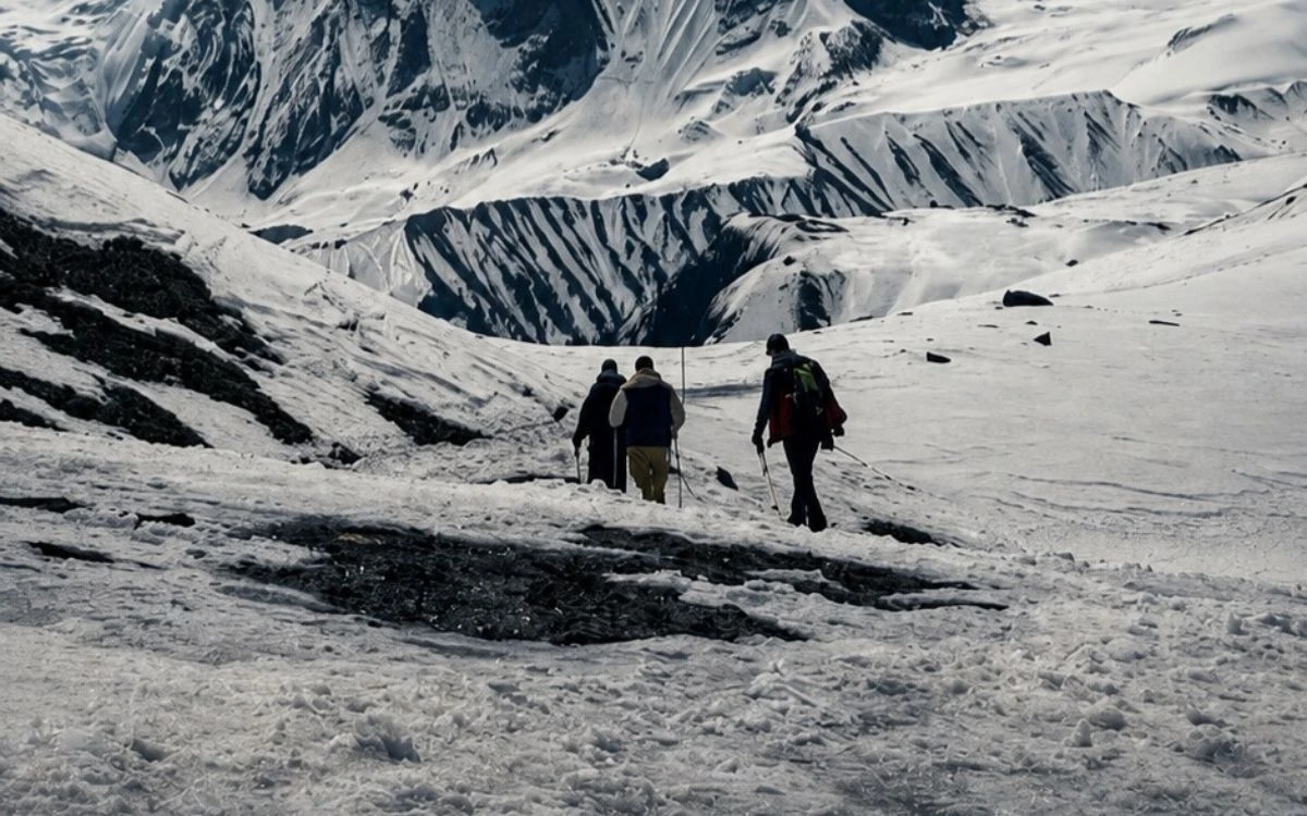 Trekkers crossing a snowfield in the Annapurna region