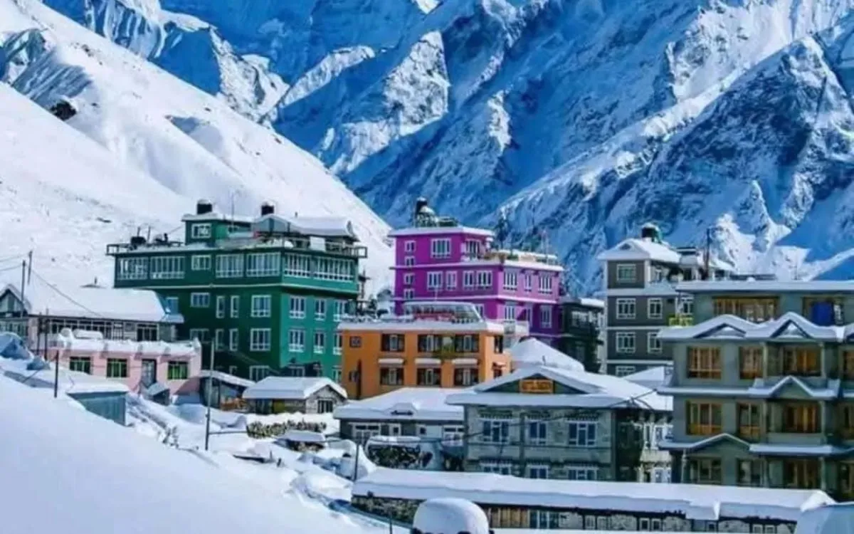 Colorful teahouses and lodges covered in snow in Himalayan village