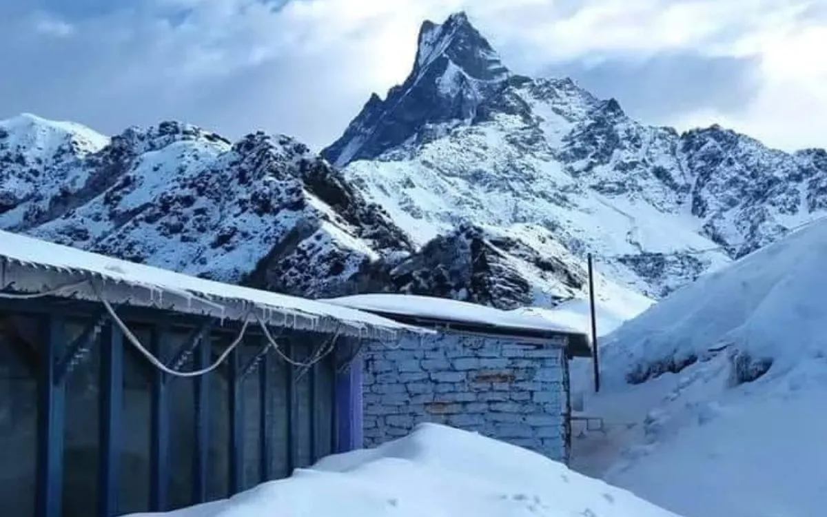 Colorful teahouses and lodges covered in snow in Himalayan village