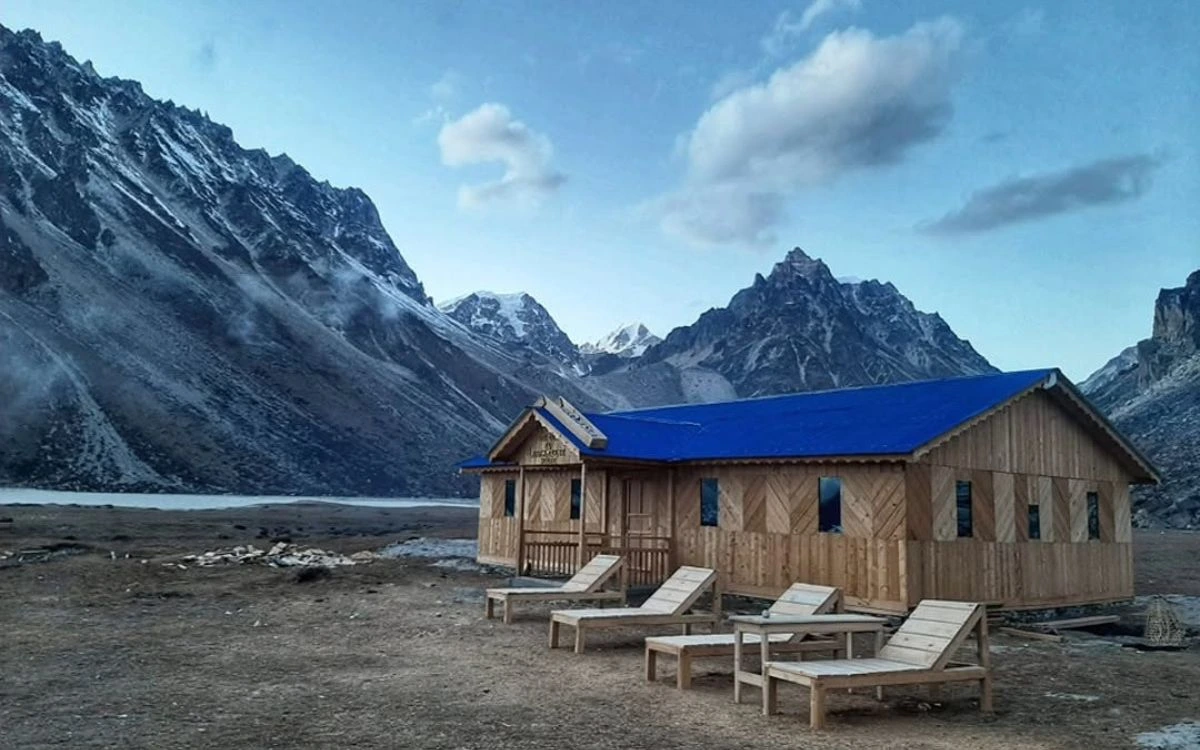 A wooden teahouse lodge with sun loungers in a remote high-altitude valley on the Kanchenjunga Trek