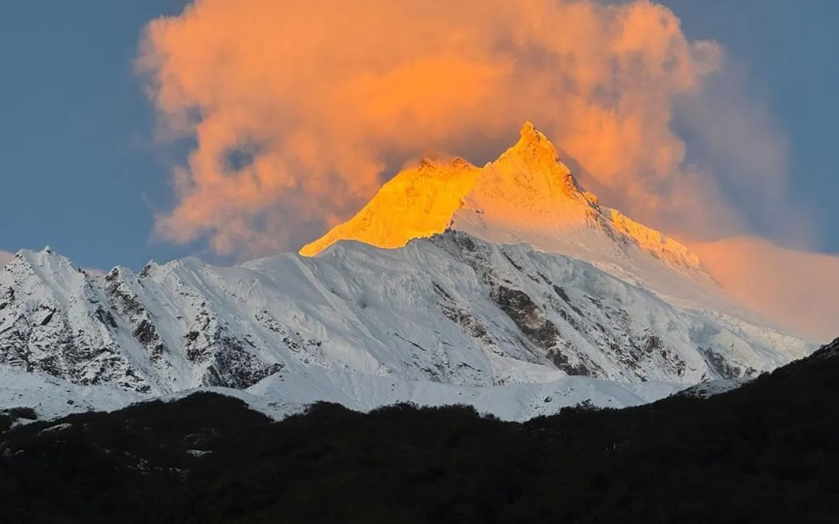 Golden sunset alpenglow on Mount Manaslu peak (8,163m) viewed from Larke Pass trekking route in Nepal Himalayas