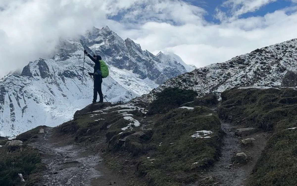 olo trekker with backpack viewing Mount Manaslu and surrounding Himalayan peaks on Larke Pass approach trail