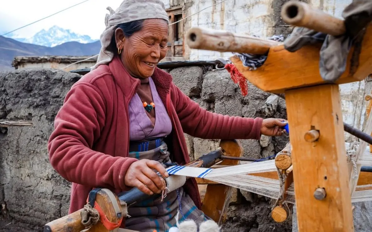 Nepali woman weaving traditional fabric in mountain village