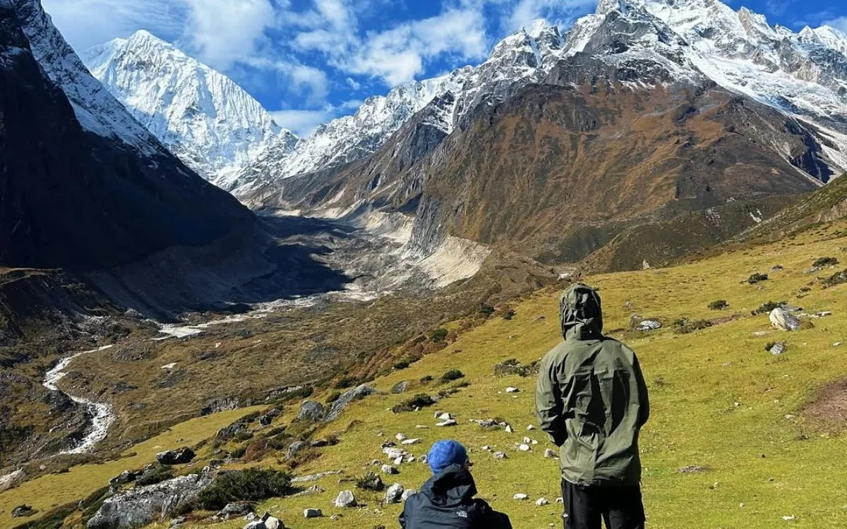 Trekkers viewing snow-capped Manaslu mountains along the trail
