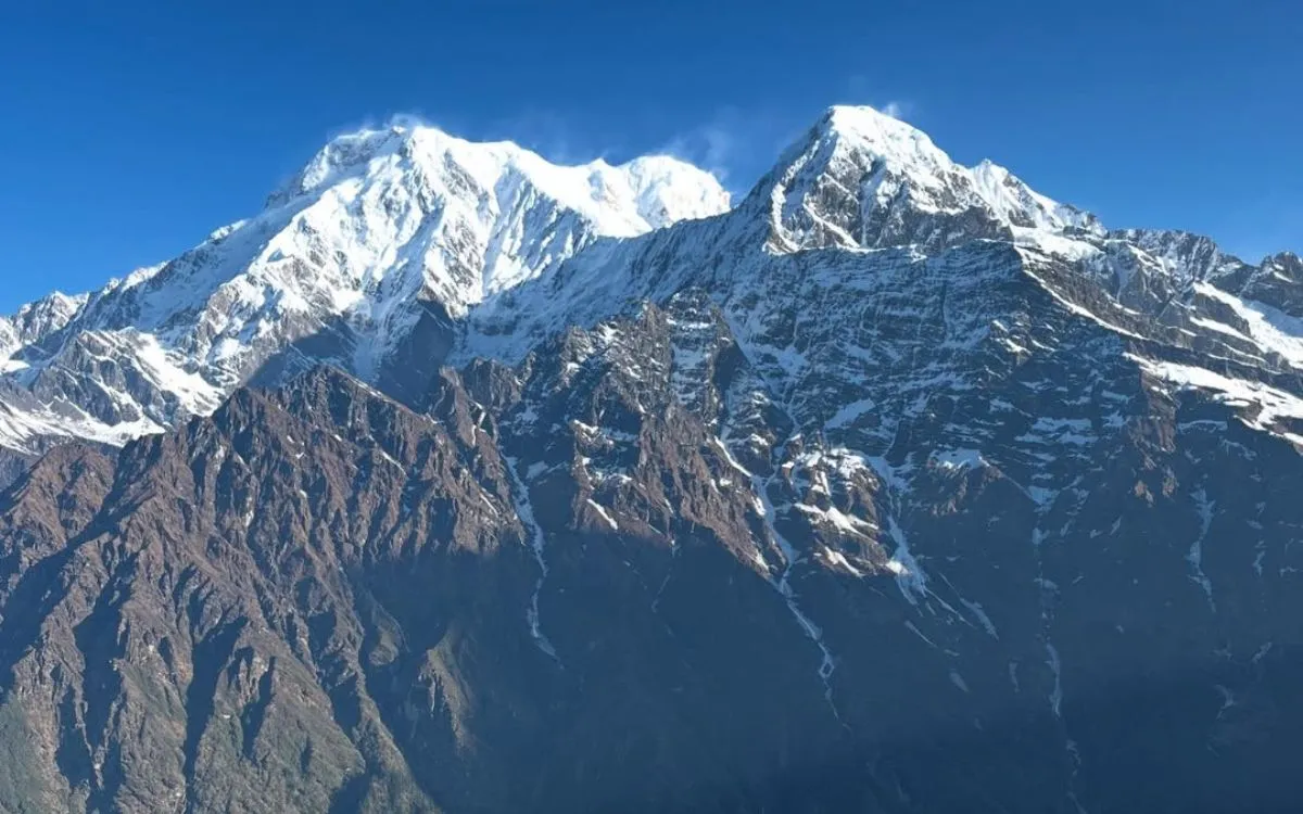 Panoramic view of Annapurna South and Hiunchuli peaks from Mardi Himal viewpoint showing snow-covered summits, glaciers, and rocky south face