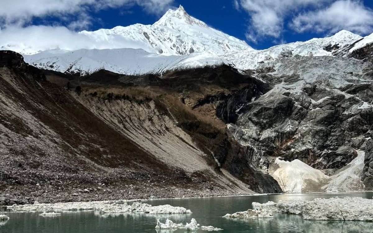 Birendra Lake glacial lake with icebergs below Manaslu peak and Pungyen Glacier Manaslu Circuit trek