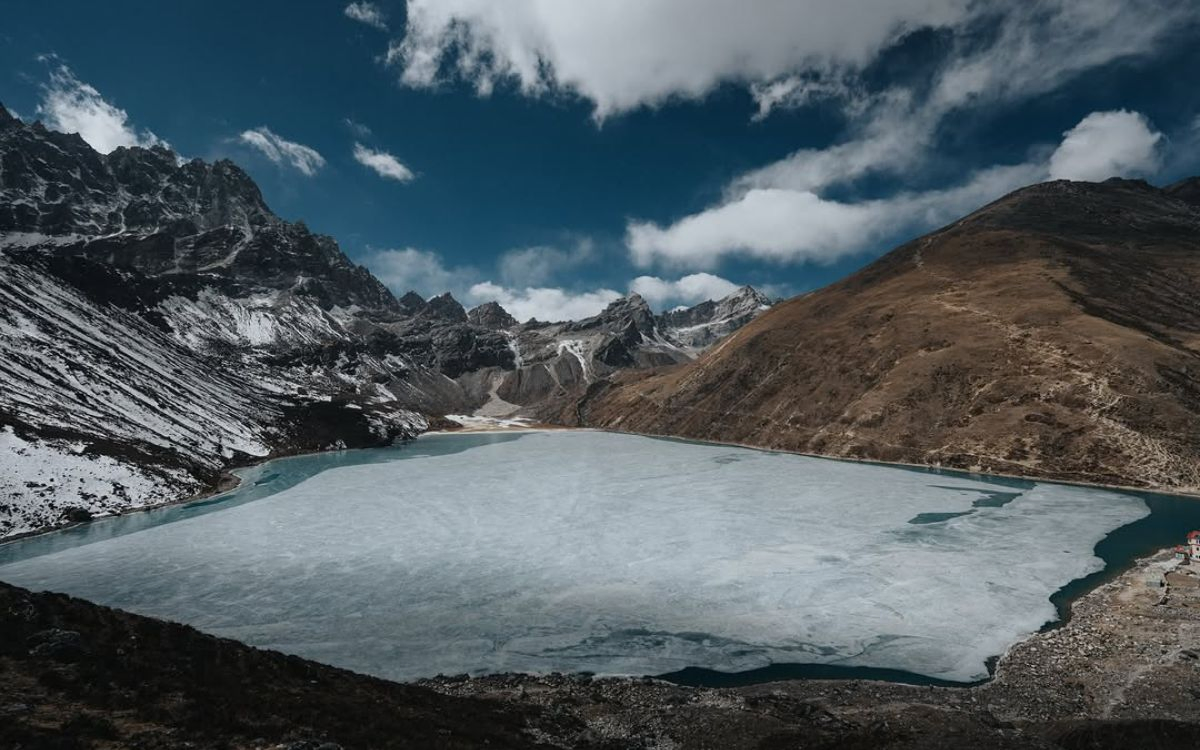 rozen turquoise waters of Gokyo Lake in the Everest region